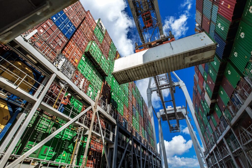 Busy container port with cranes loading cargo, illustrating global trade and economic activity.