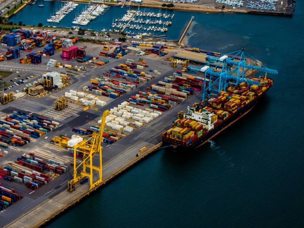 Container port operations with cargo ship loading at terminal amid global port congestion