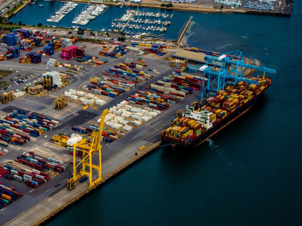 Container port operations with cargo ship loading at terminal amid global port congestion